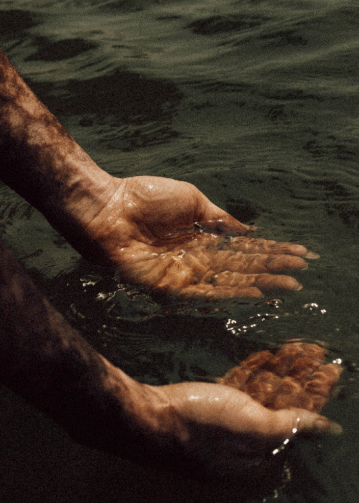 Home 1 Two hands scooping up water after trauma therapy session in California.